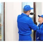 Artisans menuisiers posant une fenêtre