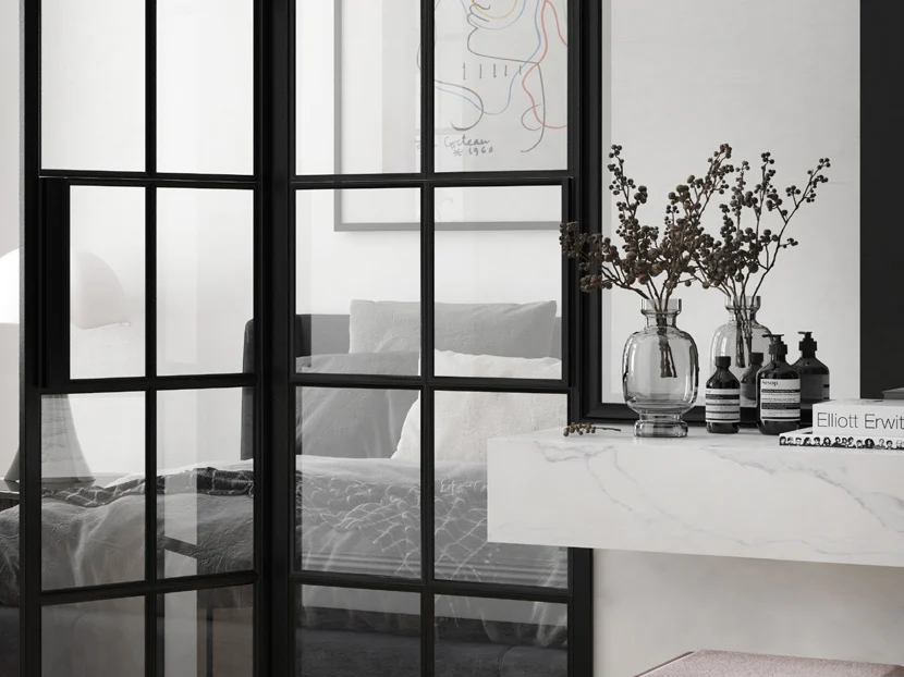 Portes vitrées style atelier en acier noir ouvrant sur une chambre